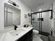 This bathroom offers a black framed glass shower and a vanity with a sink at 1310 Briarwood Ave, Deltona, FL 32725