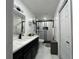 This bathroom offers a black framed glass shower and a vanity with double sinks at 1310 Briarwood Ave, Deltona, FL 32725