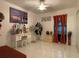 The bedroom features tile floors, a ceiling fan, vanity and bridge artwork above window at 1310 Briarwood Ave, Deltona, FL 32725