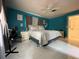 Spacious bedroom features white tile floors, bright blue walls, and ample natural light at 1310 Briarwood Ave, Deltona, FL 32725