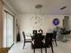 Open dining area with modern lighting, space for six, and sliding glass doors at 1310 Briarwood Ave, Deltona, FL 32725