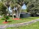 A quaint home with a green lawn and palm trees at 1310 Briarwood Ave, Deltona, FL 32725