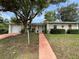 Charming one-story home with a well-manicured lawn and a vibrant walkway at 1310 Briarwood Ave, Deltona, FL 32725
