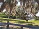 Lush green space featuring mature trees, a tranquil waterfront, and inviting picnic areas for outdoor relaxation at 1310 Briarwood Ave, Deltona, FL 32725