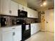 The kitchen features white cabinets, granite countertops, a tile backsplash and new stainless steel appliances at 1310 Briarwood Ave, Deltona, FL 32725