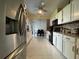 Bright kitchen with sleek appliances, modern cabinets, and a view into the dining area at 1310 Briarwood Ave, Deltona, FL 32725