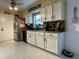 Well-lit kitchen featuring granite countertops, tile backsplash, and stainless steel appliances at 1310 Briarwood Ave, Deltona, FL 32725