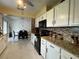Open kitchen with white cabinetry, granite countertops and a view into an open dining area at 1310 Briarwood Ave, Deltona, FL 32725