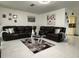 Spacious living room with a large leather sofa and modern décor at 1310 Briarwood Ave, Deltona, FL 32725