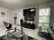 Bright living room featuring a decorative fireplace and large windows at 1310 Briarwood Ave, Deltona, FL 32725