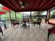 The patio offers tile floors, a ceiling fan, and wicker furniture at 1310 Briarwood Ave, Deltona, FL 32725