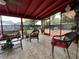 This patio offers tile floors, a ceiling fan, and wicker furniture at 1310 Briarwood Ave, Deltona, FL 32725