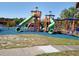 Community playground with multiple slides, climbing structures, and ample play space for recreation at 1310 Briarwood Ave, Deltona, FL 32725