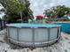 View of above ground pool and patio area with umbrellas and seating, perfect for summer fun and relaxation at 1310 Briarwood Ave, Deltona, FL 32725