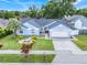 An elevated view of a lovely one-story home with a manicured lawn and a two-car garage at 1322 Ravida Woods Dr, Apopka, FL 32703