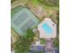 Overhead view of tennis courts, playground, and pool with lounge chairs at 1322 Ravida Woods Dr, Apopka, FL 32703