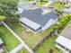 Aerial view of property featuring fenced backyard, roof, and mature trees at 1322 Ravida Woods Dr, Apopka, FL 32703