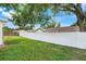 Fenced backyard with mature trees and green grass at 1322 Ravida Woods Dr, Apopka, FL 32703
