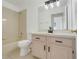 Bathroom features a vanity with black hardware and a shower-tub combo at 1322 Ravida Woods Dr, Apopka, FL 32703