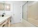 Bathroom featuring a vanity with black hardware and a tub with glass doors at 1322 Ravida Woods Dr, Apopka, FL 32703