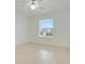 Bedroom featuring bright window and neutral tile floors at 1322 Ravida Woods Dr, Apopka, FL 32703