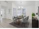 Bright dining room featuring modern chandelier, large windows, and stylish decor, creating an inviting atmosphere at 1322 Ravida Woods Dr, Apopka, FL 32703