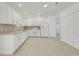 White kitchen features ample storage, tile backsplash, and modern appliances at 1322 Ravida Woods Dr, Apopka, FL 32703