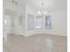 Bright living room features tile flooring, three windows and modern chandelier at 1322 Ravida Woods Dr, Apopka, FL 32703