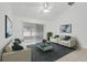 Cozy living room with vaulted ceiling, comfortable seating, and sliding doors for a bright and airy feel at 1322 Ravida Woods Dr, Apopka, FL 32703