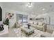 Inviting living room with screened porch access, a neutral color palette and a smooth transition to the kitchen at 1322 Ravida Woods Dr, Apopka, FL 32703