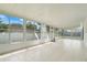 The bright sunroom features tiled flooring, multiple windows, and plenty of natural light at 1322 Ravida Woods Dr, Apopka, FL 32703