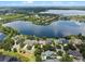 Aerial view of a home with a lake in the background, showcasing the property lines at 13838 Bluebird Park Rd, Windermere, FL 34786