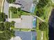 Aerial shot of homes, pools, and landscaping showcasing a lakefront property at 13838 Bluebird Park Rd, Windermere, FL 34786