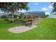 Landscaped backyard featuring a patio, garden beds, and a staircase leading to the pool at 13838 Bluebird Park Rd, Windermere, FL 34786