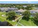 Aerial view of the backyard featuring a screened-in pool and landscaping close to the waterfront at 13838 Bluebird Park Rd, Windermere, FL 34786