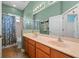 The bathroom features a shower, dual sinks, and mint green walls at 13838 Bluebird Park Rd, Windermere, FL 34786