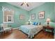 Bedroom with wood floors, a window with blinds, and a cozy sitting area at 13838 Bluebird Park Rd, Windermere, FL 34786