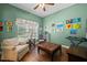 Inviting bedroom with natural light, hardwood floors, and a cozy seating area, perfect for relaxing at 13838 Bluebird Park Rd, Windermere, FL 34786