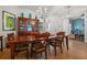 Classic dining room featuring a wooden table, chairs, china cabinet, and stylish lighting at 13838 Bluebird Park Rd, Windermere, FL 34786