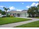 Charming single-story home with a well-manicured lawn, a brick driveway, and inviting curb appeal at 13838 Bluebird Park Rd, Windermere, FL 34786