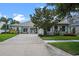 Charming single-story home featuring a brick driveway, manicured lawn, and welcoming front porch at 13838 Bluebird Park Rd, Windermere, FL 34786