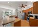 Well-equipped kitchen with modern appliances and adjacent breakfast nook with bay window overlooking the water at 13838 Bluebird Park Rd, Windermere, FL 34786