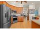Modern kitchen featuring stainless steel appliances, wooden cabinets, and a view to the adjacent dining area at 13838 Bluebird Park Rd, Windermere, FL 34786