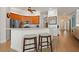 Open kitchen with wooden cabinets, stainless steel appliances, and a breakfast bar with barstool seating at 13838 Bluebird Park Rd, Windermere, FL 34786