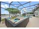 Screened pool area with a lake view and outdoor seating, perfect for enjoying the outdoors at 13838 Bluebird Park Rd, Windermere, FL 34786