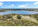 Wide aerial shot highlighting the vastness of the property, bordered by a tranquil lake and mature trees at 14243 County Road 450, Umatilla, FL 32784