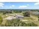 Gorgeous aerial view displaying the home, its expansive land, and a tranquil nearby lake at 14243 County Road 450, Umatilla, FL 32784