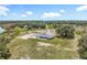 Stunning aerial view of the home, its sprawling property, and proximity to a beautiful lake at 14243 County Road 450, Umatilla, FL 32784