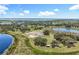 Expansive aerial view of property featuring picturesque lakes, sprawling greenery, and a charming single-story home at 14243 County Road 450, Umatilla, FL 32784