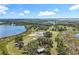 Captivating aerial view showcasing the property's surrounding natural beauty, including lush trees and serene lake at 14243 County Road 450, Umatilla, FL 32784